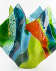 Second image of fused glass fold form vase, with bright greens and textural detailing. 