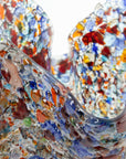 Textured detailing of a fold form fused glass vase, handmade using recycled glass in vibrant colours. 