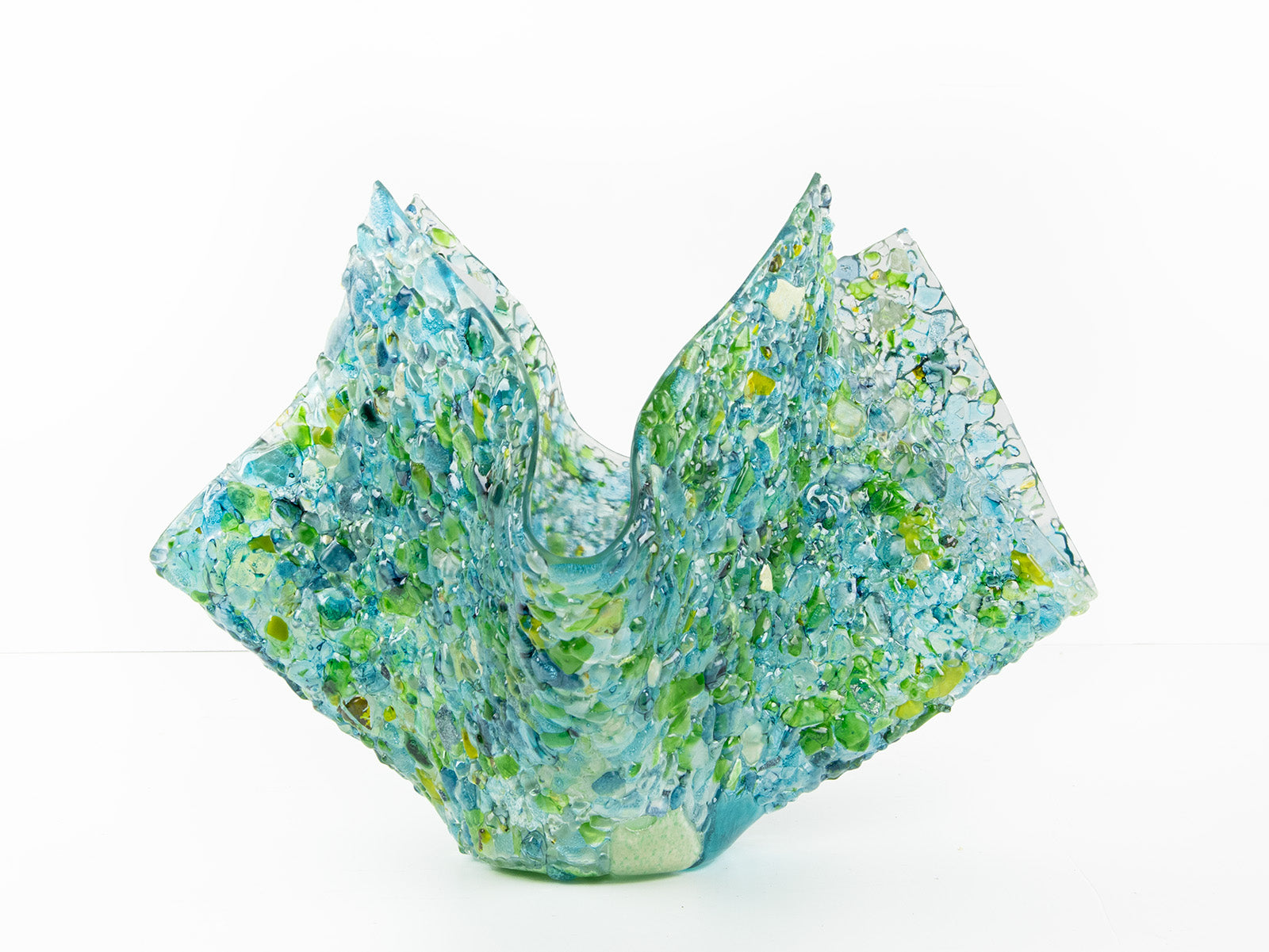 Left side of fused glass large vase, handmade from recycled glass in ocean green and blue hues. 