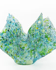 Left side of fused glass large vase, handmade from recycled glass in ocean green and blue hues. 