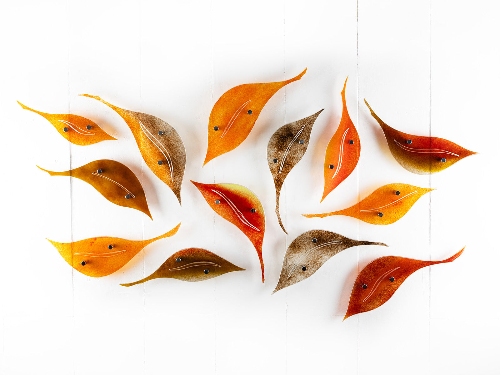 Fused glass autumn leaf wall art display, in  vibrant orange and natural browns. 