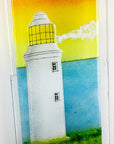 Details of fused glass wall panel, featuring a Cornish lighthouse design with a sunset sky. 