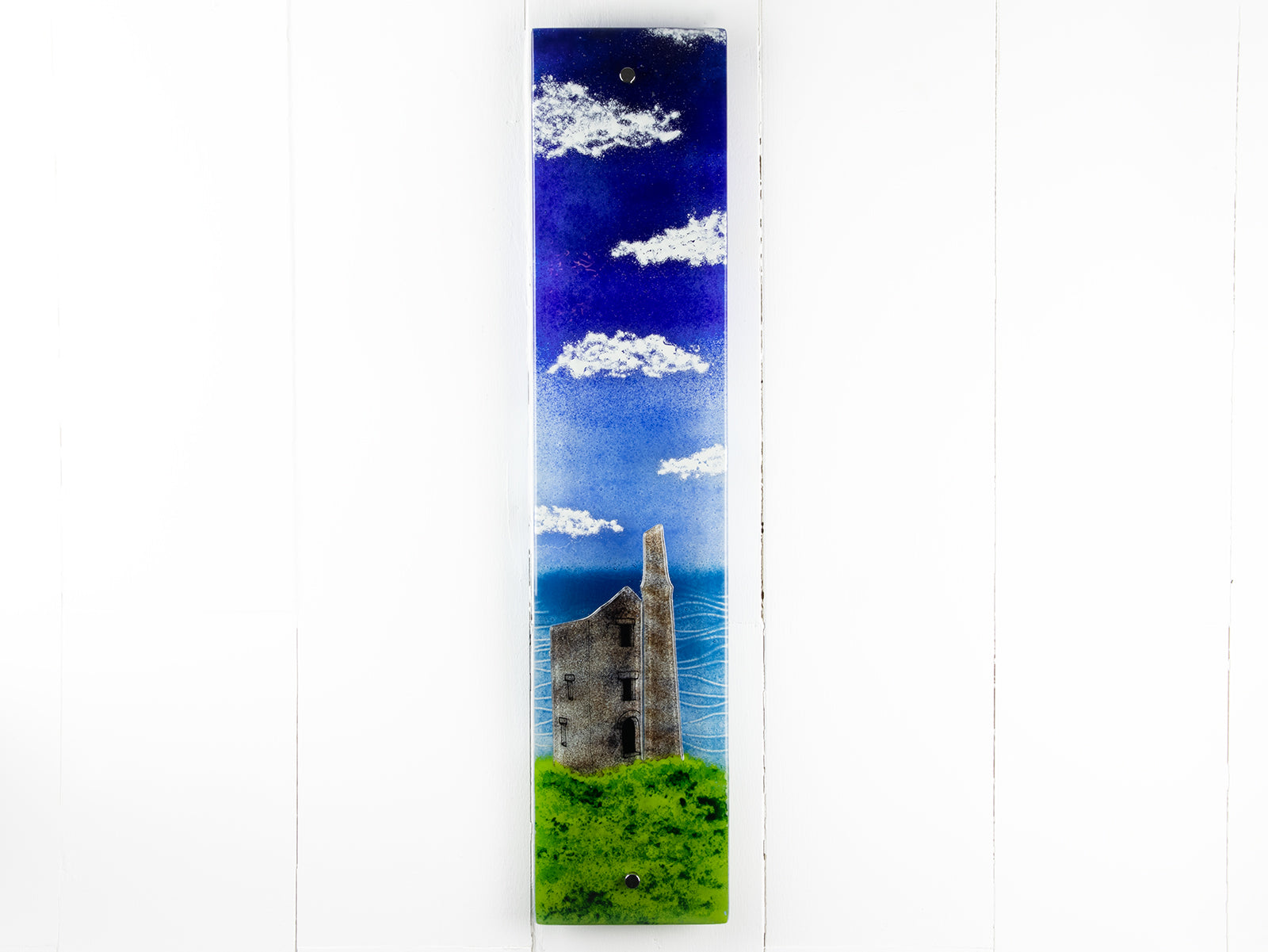 Fused glass wall panel featuring a Cornish lighthouse sat against a coastal blue design.  
