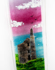 Close up of fused glass wall panel featuring a Cornish tin mine, with a vibrant sunset sky and soaring gulls. 