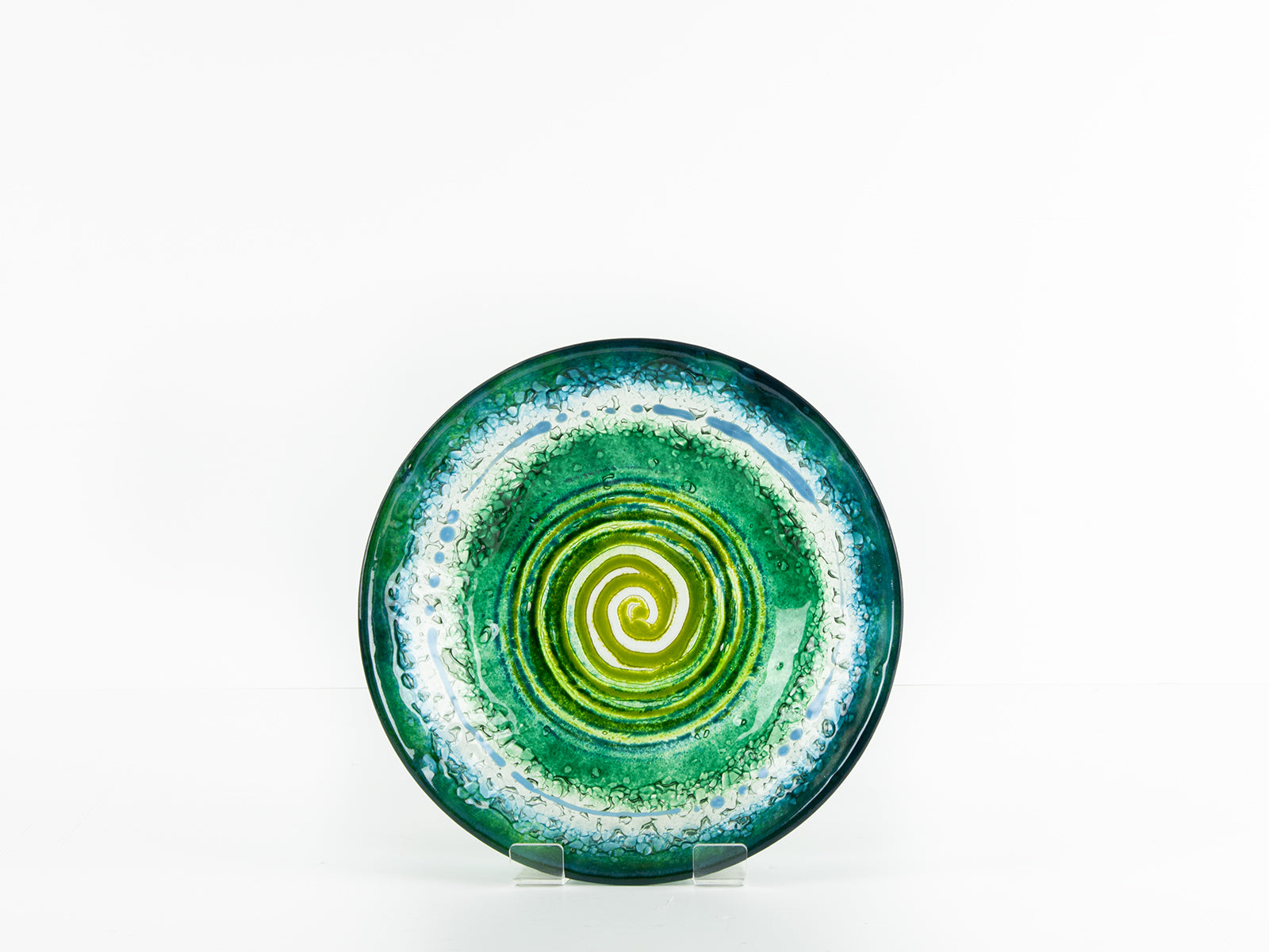 Fused glass round dish, featuring a dark emerald colour-way and a textured swirling detailing. 