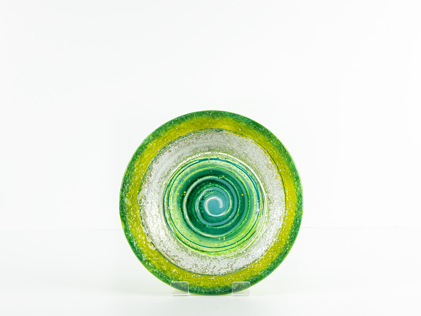 Fused glass round dish in emerald green colours and organic swirling details.