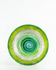 Fused glass round dish in emerald green colours and organic swirling details.