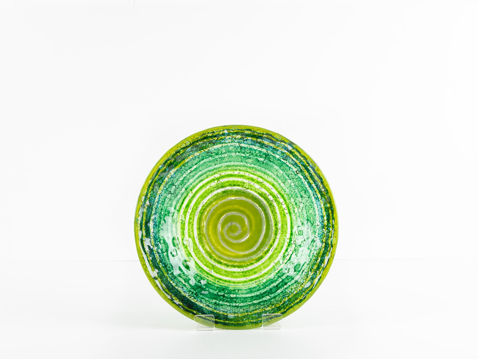 Fused glass round dish, featuring an emerald green colour-way and swirling design. 