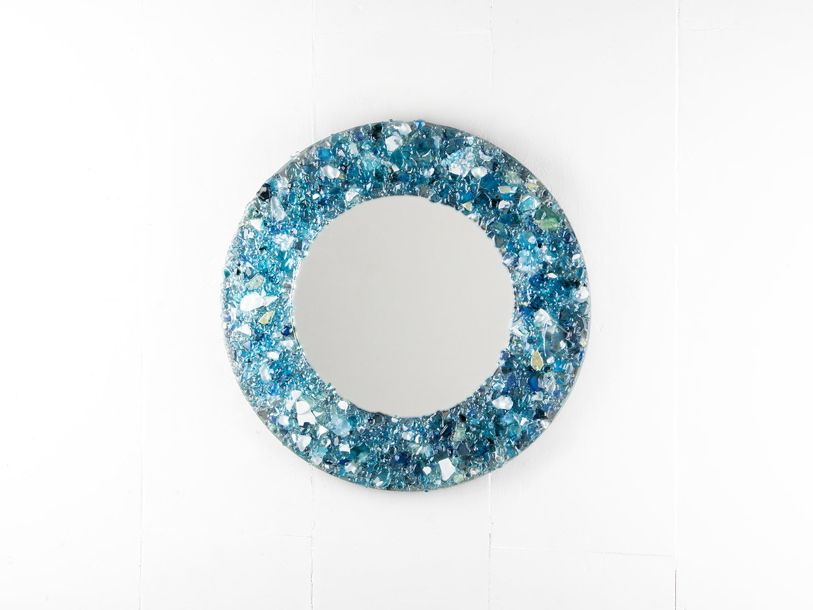 Fused glass round mirror, made from recycled glass in coastal blues. 