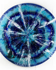 Fused glass round panel, designed in sea blues and organic textural detailing. 