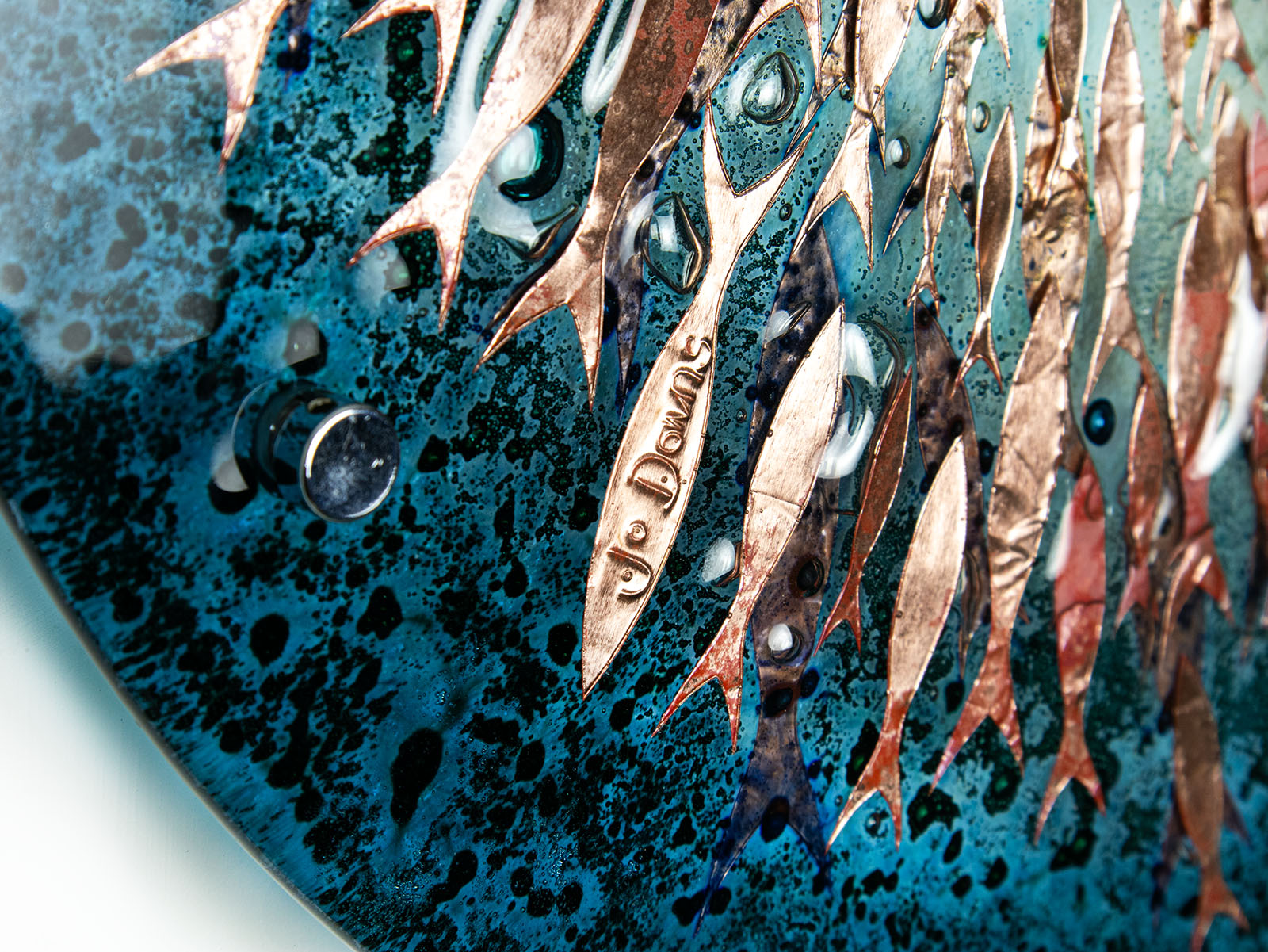 Etched signature on a copper fish on an ocean inspired fused glass wall art design.