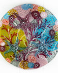 Fused glass round wall panel with starfish and ocean reef design in pinks and sea blues. Intricate and hand-made piece of wall art. 