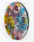 Fused glass round wall panel with starfish and ocean reef design in pinks and sea blues. Intricate and hand-made piece of wall art. 