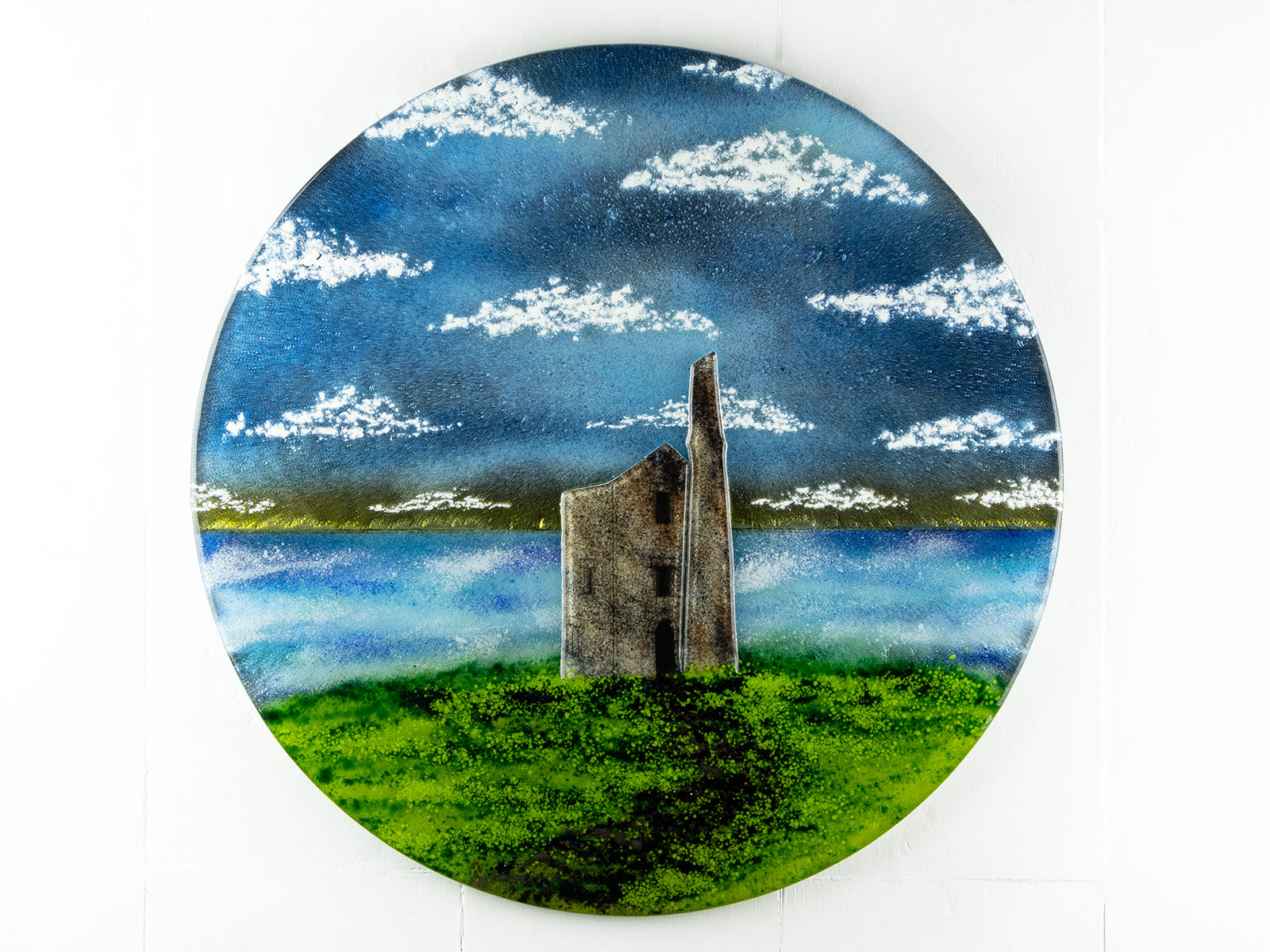 Fused glass round wall panel, featuring Cornish Tin Mine, in coastal design. 