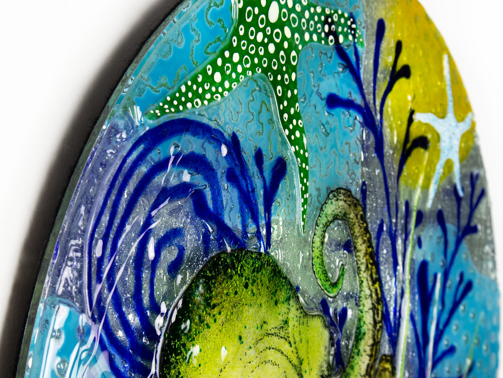 Close up of blue organic background on a fused glass panel with a ocean reef inspired design. 