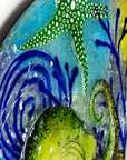 Close up of blue organic background on a fused glass panel with a ocean reef inspired design. 