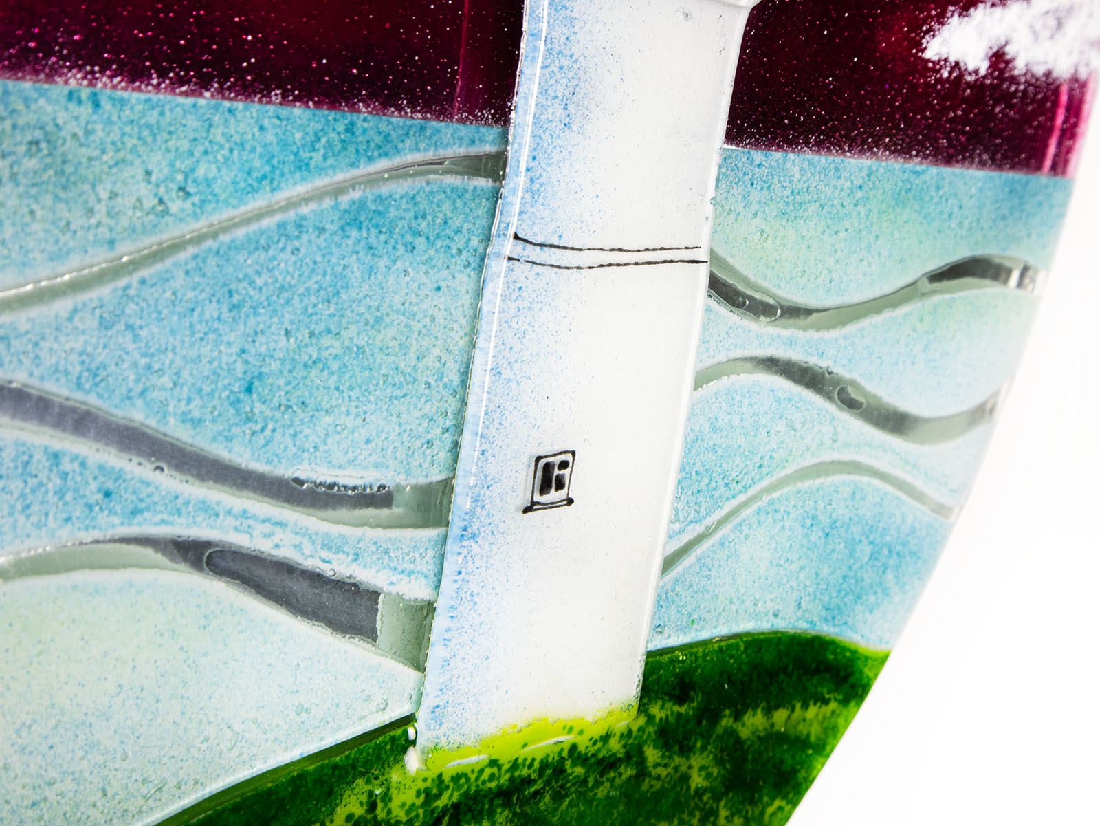 Details of a lighthouse on a fused glass round panel. 
