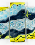 Fused glass triptych with swirling detailing and starfish, capturing a gorgeous ocean design. 