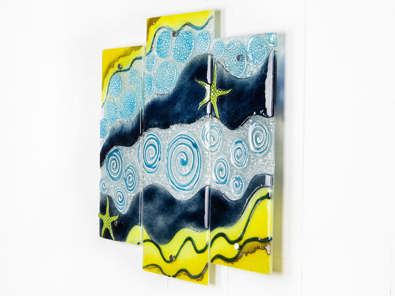 Fused glass triptych inspired by the ocean with starfish detailing and coastal colours. 