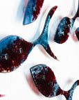 Close up of fused glass shoal of fish in a soft blue and textured burgundy colour-way.