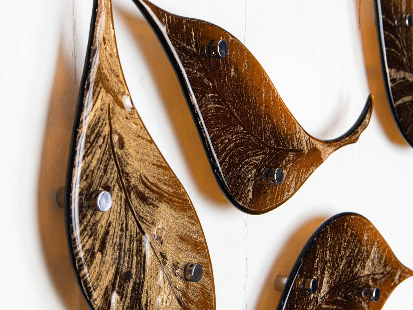 Close up of fused glass drift of leaves as a gorgeous wall art display in autumn browns and golds. 