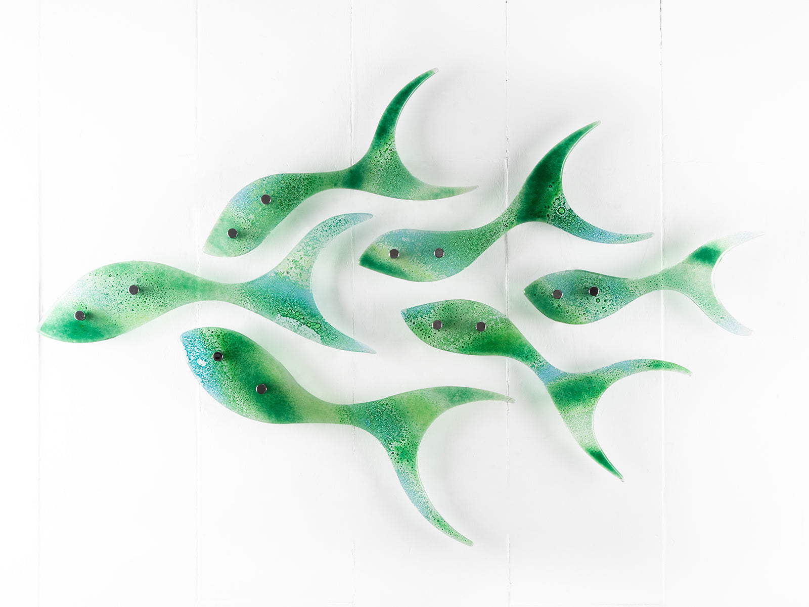 Fused glass shoal of fish in a sea green and aqua colour-way. 