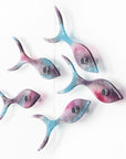 Fused glass shoal of fish on a wall, handmade in bright pinks and coastal blues.