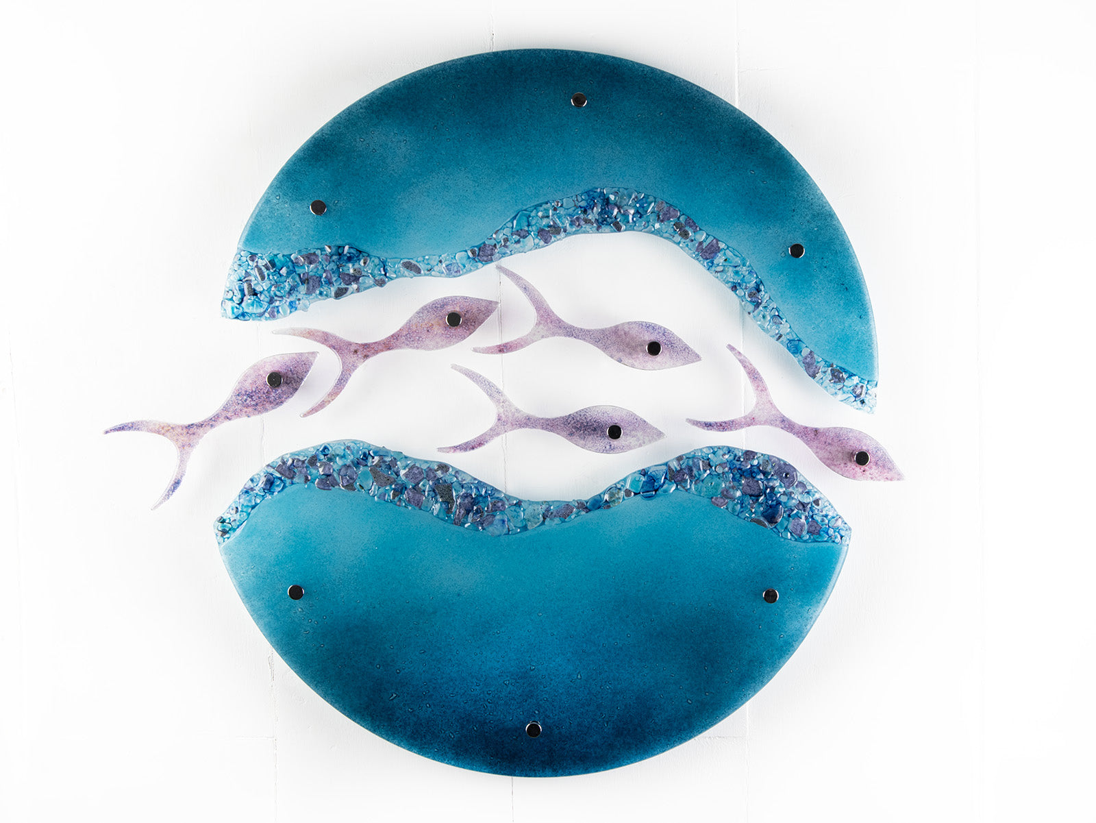 Fused glass wall art display with shoal of fish and coastal blue colours. 