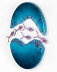 Fused glass wall art display with shoal of fish and coastal blue colours. 