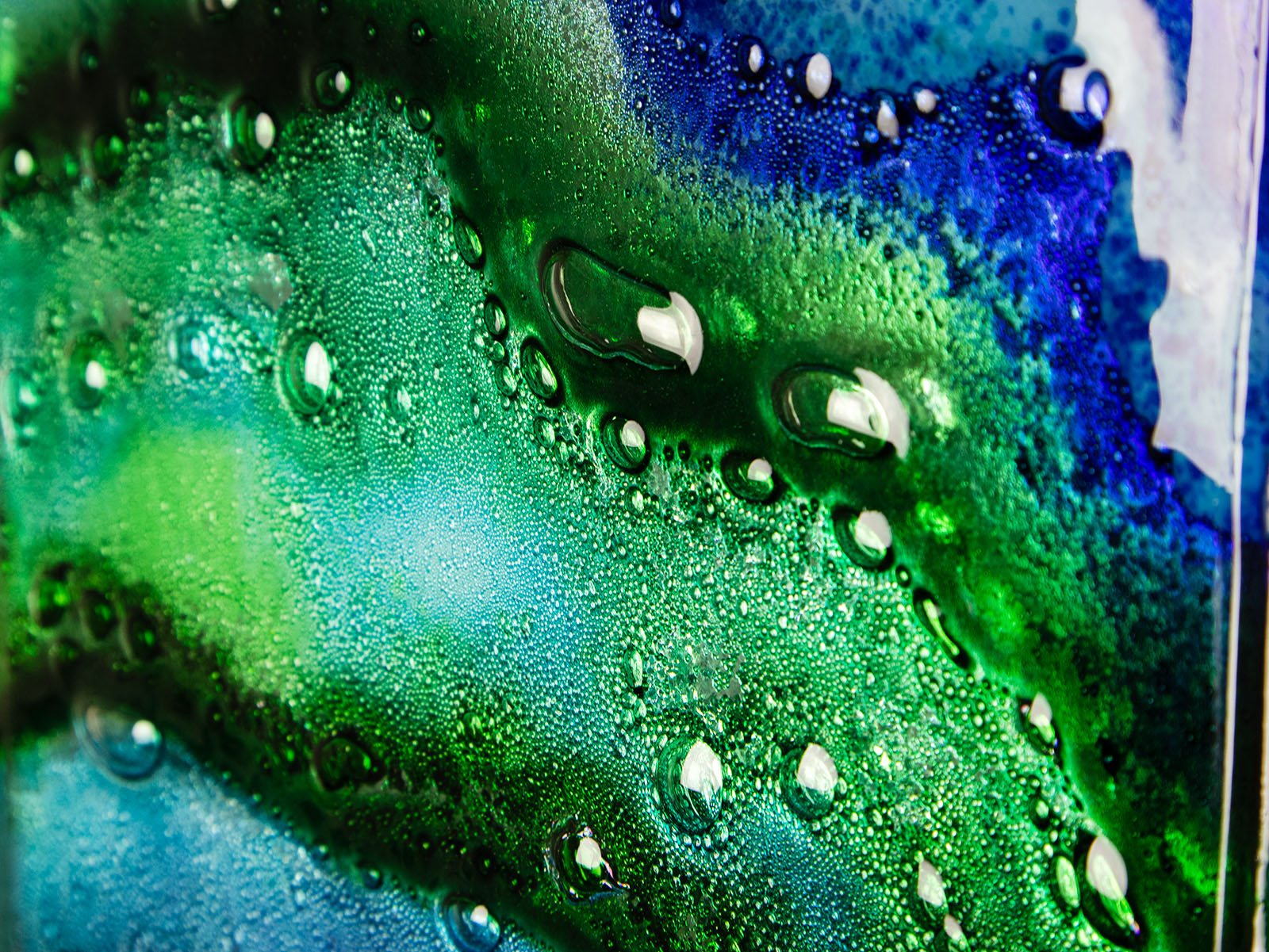 Bubbled details on abstract and bright fused glass wall panel, inspired by the ocean with coastal colours.