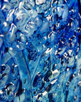 Close up of a fused glass ocean inspired wall panel with texture and bright blues.