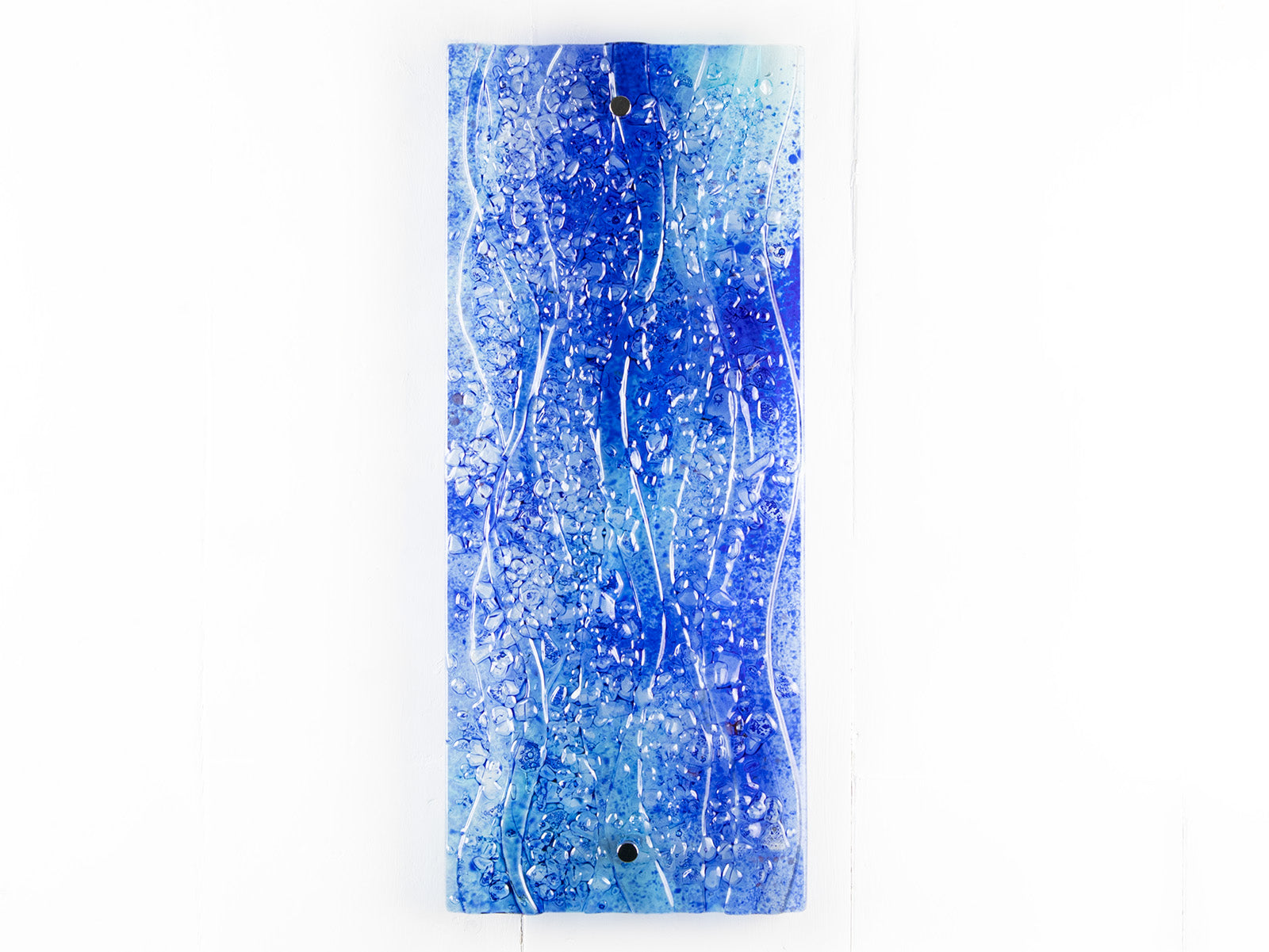 Fused glass ocean inspired wall panel with texture and bright blues.