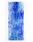 Fused glass ocean inspired wall panel with texture and bright blues.