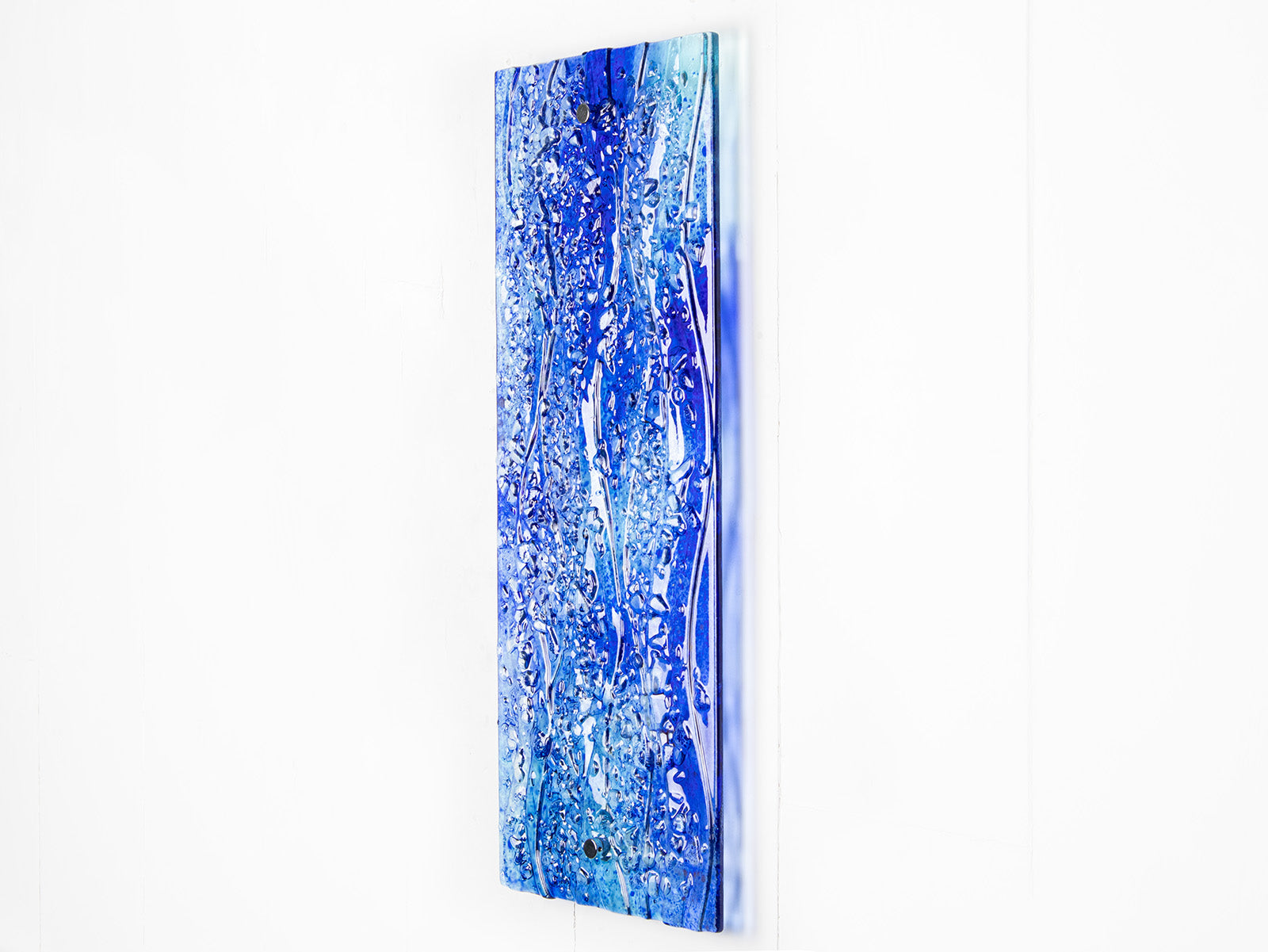 Fused glass ocean inspired wall panel with texture and bright blues.