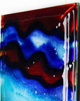 Close up of abstract and bright fused glass wall panel, inspired by the atmosphere of the ocean, with coastal colours and bubbled detailing. 