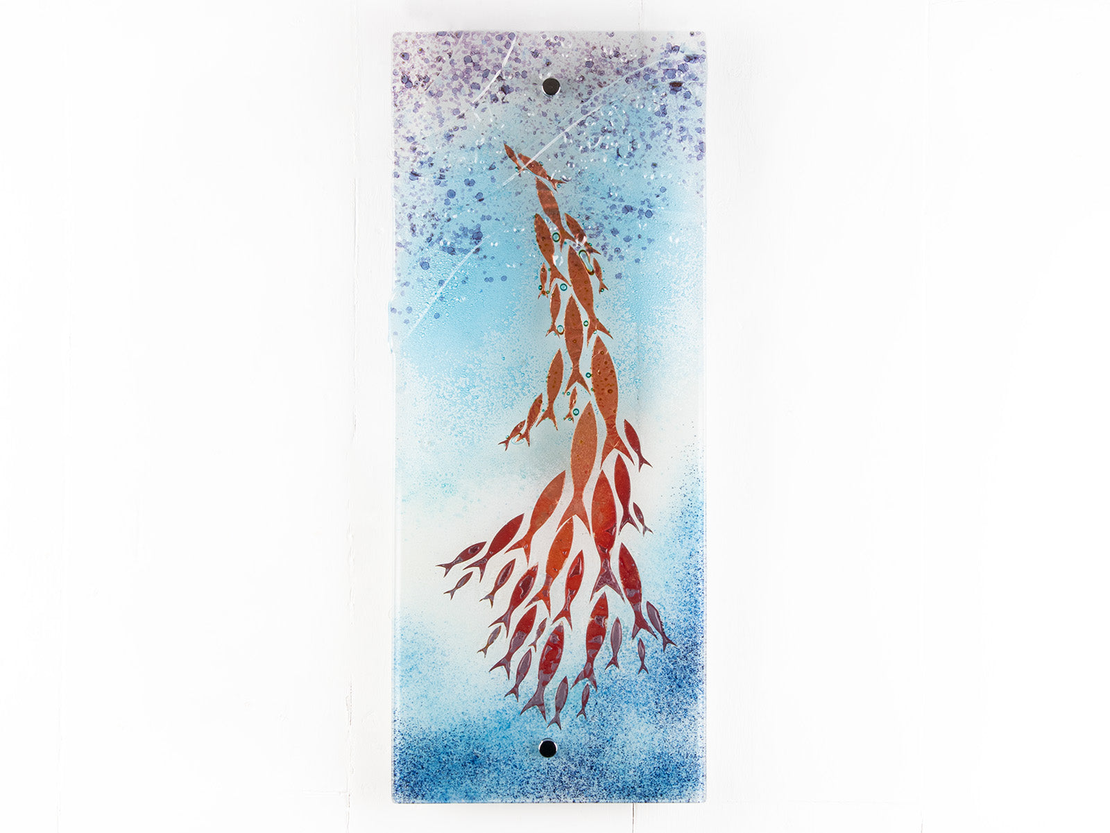 Fused glass wall panel in an ocean inspired design with copper fish and soft ocean colours. 