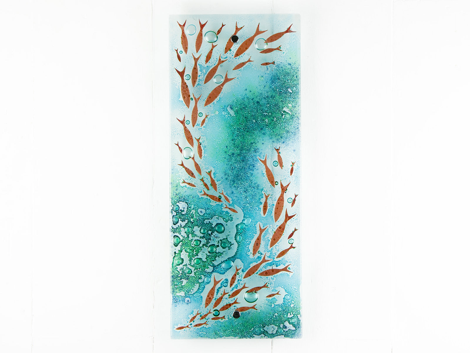 Fused glass wall panel with coastal green colours and copper fish. wall art piece inspired by the ocean.