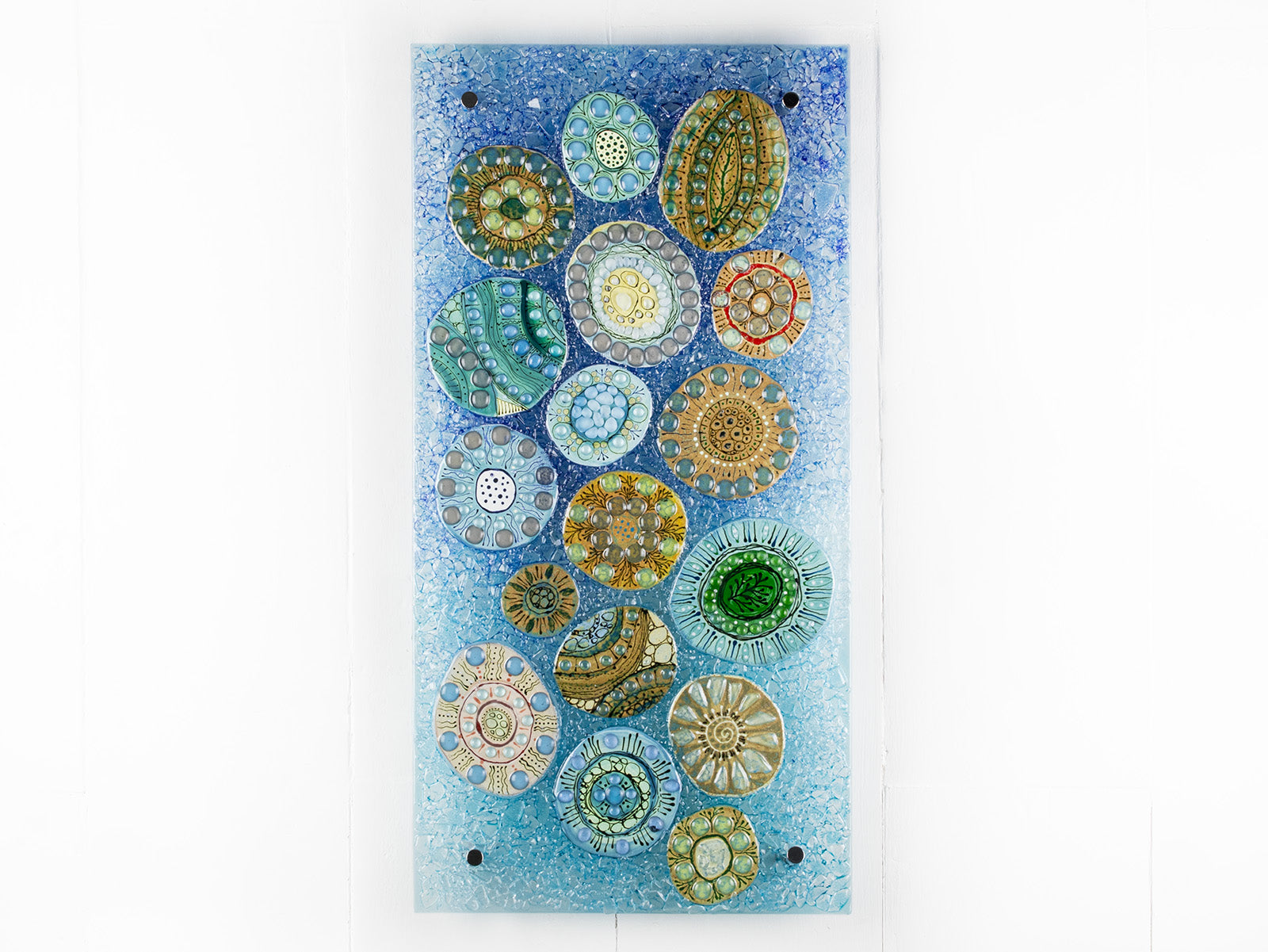 Fused glass wall panel, designed with organic textural detail and aqua, marine blues.