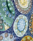 Details of fused glass wall panel, designed with organic textural detail and aqua, marine blues.