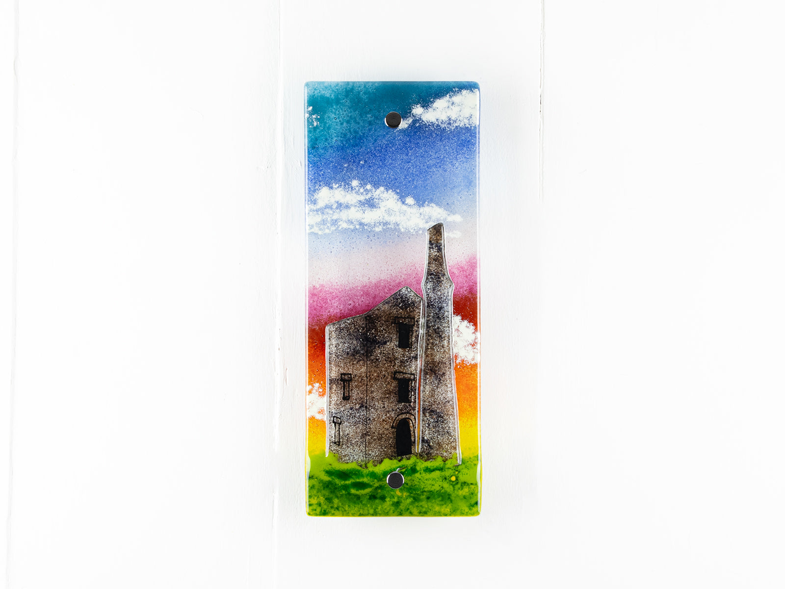 Small fused glass wall panel, featuring a tin mine design, with vibrant sunset sky. 