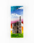 Small fused glass wall panel, featuring a tin mine design, with vibrant sunset sky. 