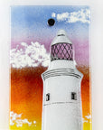 Details of handmade wall panel featuring a lighthouse with bright sunset colours. Gorgeous Artisan wall art piece, designed in Cornwall. 