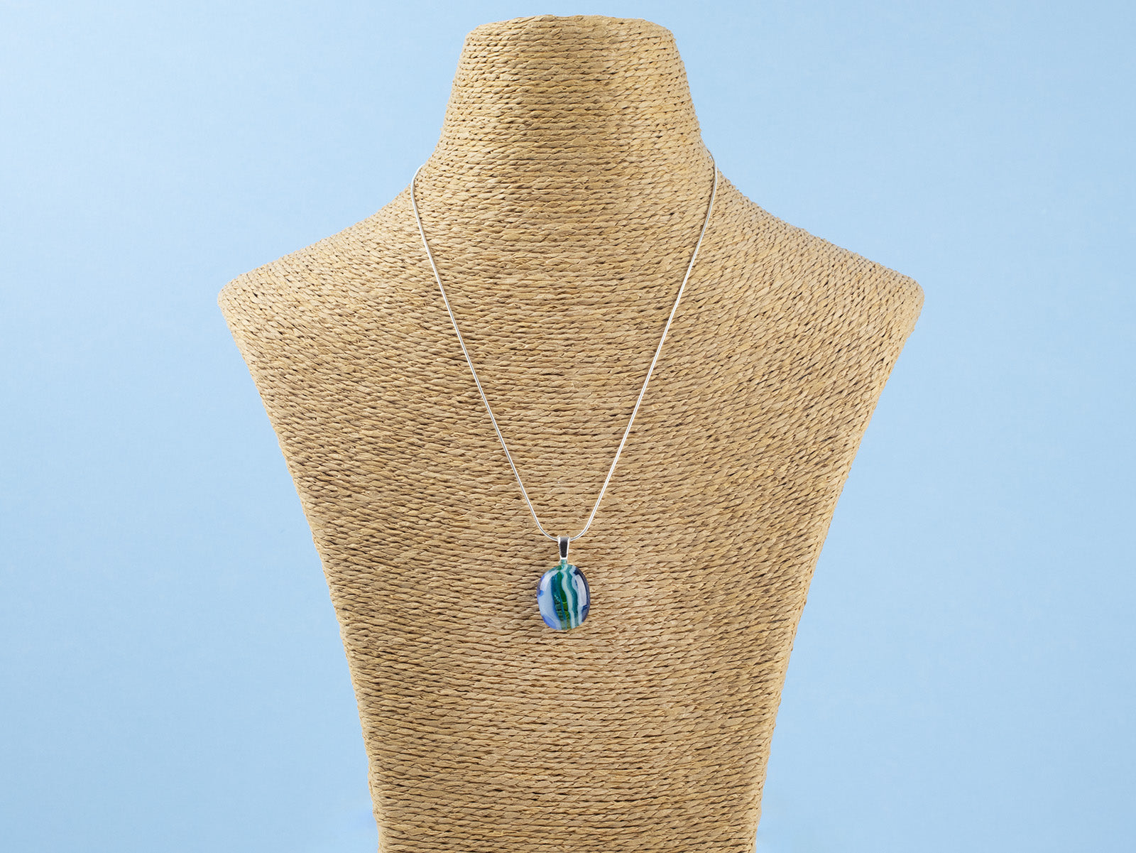 Fused glass necklace, handmade with ocean blues and hung on sterling silver chai