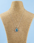 Fused glass necklace, handmade with ocean blues and hung on sterling silver chai