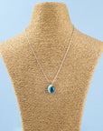 Fused glass pendant necklace, handmade in marine blues, hung on sterling silver chain. 