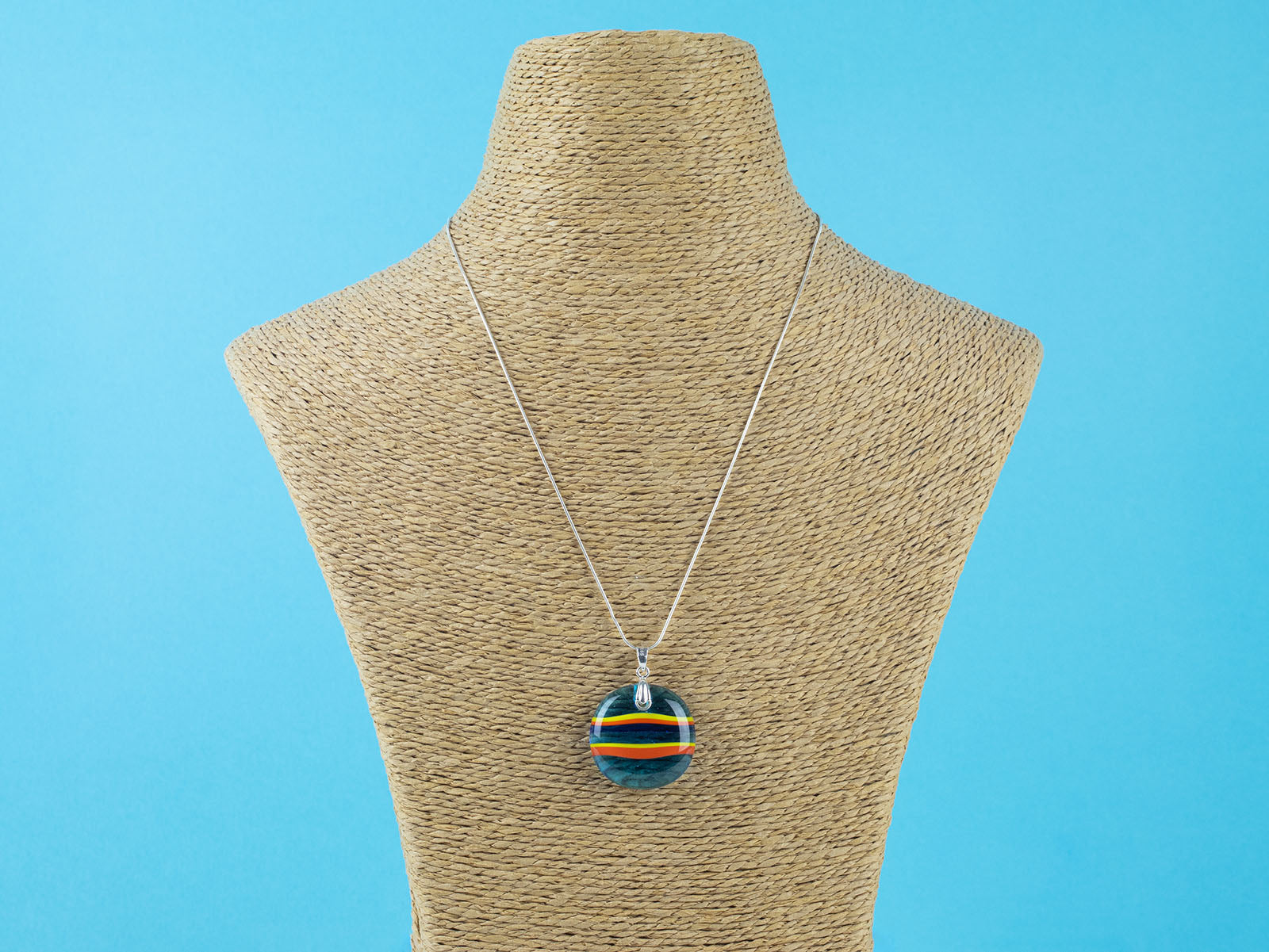 Fused glass large pendant necklace in vibrant orange and aqua blue colours. Handmade and features sterling silver chain and fixings.