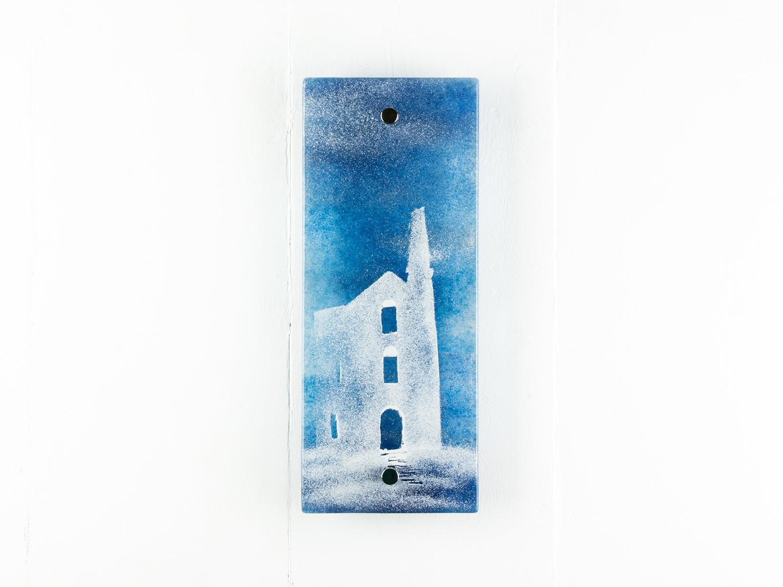 Fused glass wall panel with a deep teal colour-way and soft design of a Cornish tin mine. 