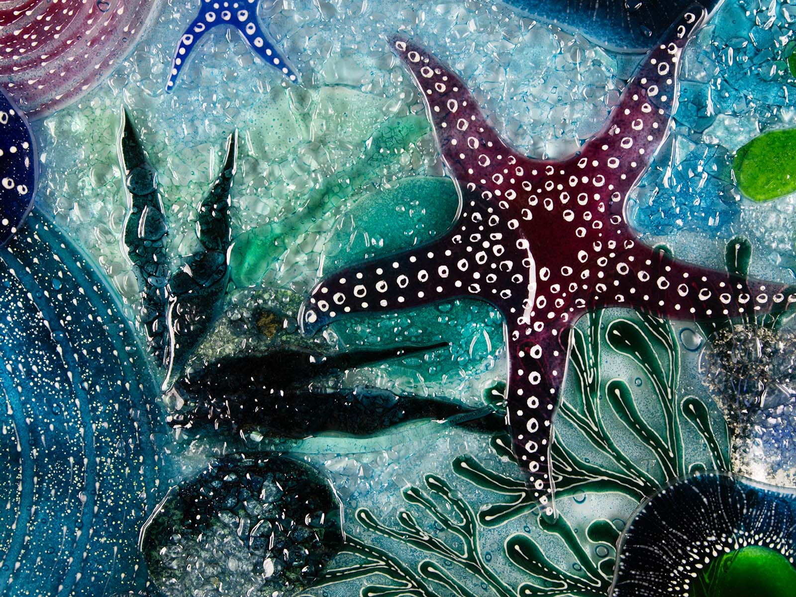 Close up of dark pink starfish on a fused glass extra large art frame, ocean reef inspired with coastal colours and texture.