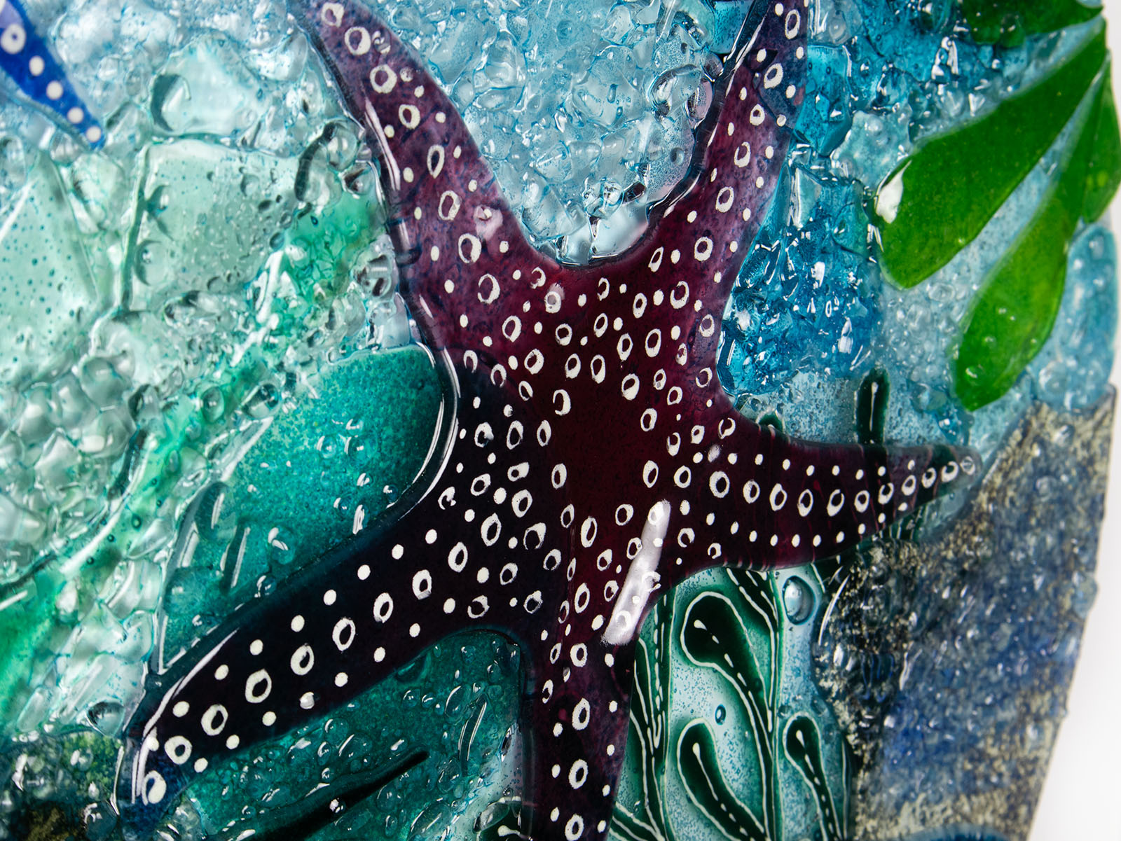 Close up of dark pink starfish on a fused glass extra large art frame, ocean reef inspired with coastal colours and texture.