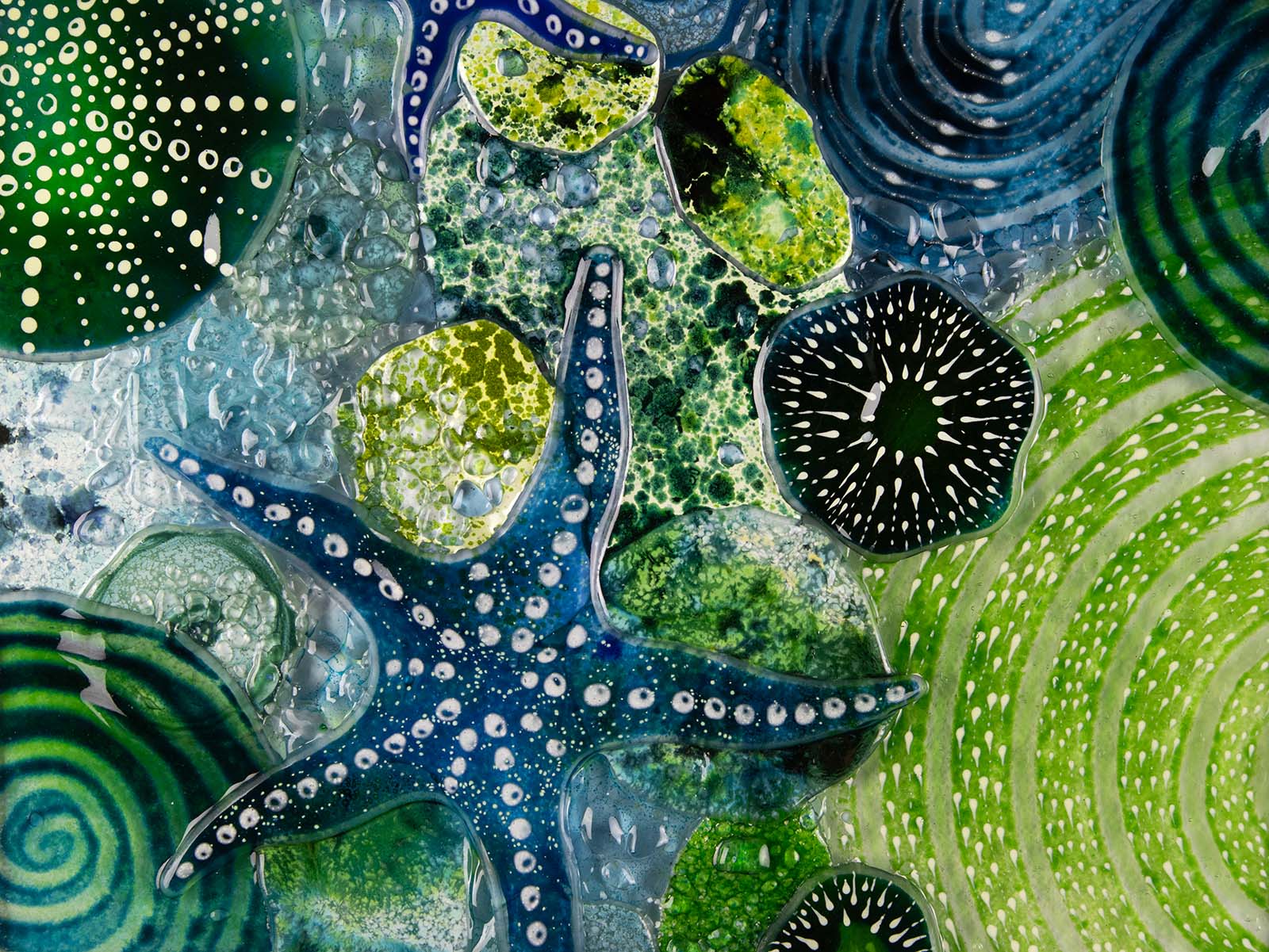 Close up of intricate ocean reef inspired fused glass art frame. Bright ocean blue colours and handmade wall art. 